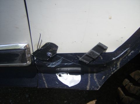 1986 Ford Bronco - Detail of vehicle's lower door and fender showing trim and attached rubber pieces.