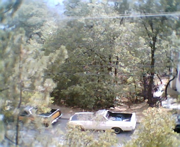 1972 Ford Ranchero - Two pickup trucks are parked in an outdoor setting with trees and foliage. The SuperMotors logo is visible.