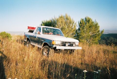 1991 Ford Bronco - This 1991 Ford Bronco is parked on a grassy hillside under a clear blue sky.
