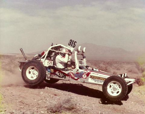 1996 Ford Bronco - A custom-built off-road buggy races across a dusty, arid landscape.
