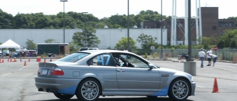 2001 Mercury Grand Marquis - Silver BMW M3 coupe with racing number 47 on the door, participating in an event on a paved lot.