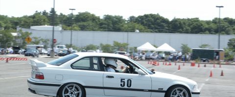 2001 Mercury Grand Marquis - A white BMW M3 with racing number 50 navigates an autocross course.