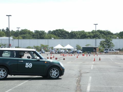 2001 Mercury Grand Marquis - A green Mini Cooper is parked in a lot with orange cones set up for an event.