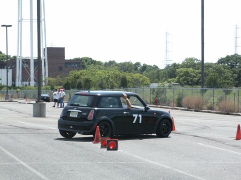 2001 Mercury Grand Marquis - A black Mini Cooper navigates an autocross course marked by orange cones.