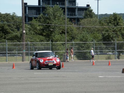 2001 Mercury Grand Marquis - A red Mini Cooper navigates an autocross course with orange cones.