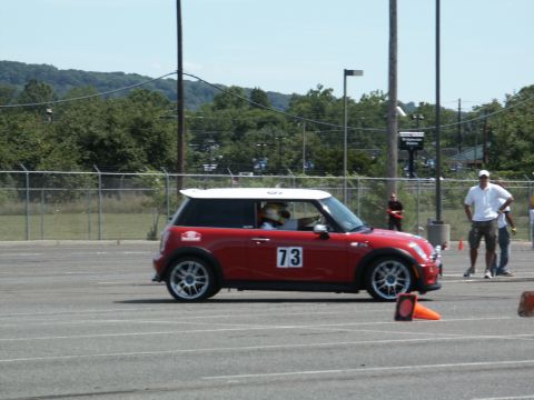2001 Mercury Grand Marquis - A red Mini Cooper with a white roof and racing number 73 participates in an autocross event.