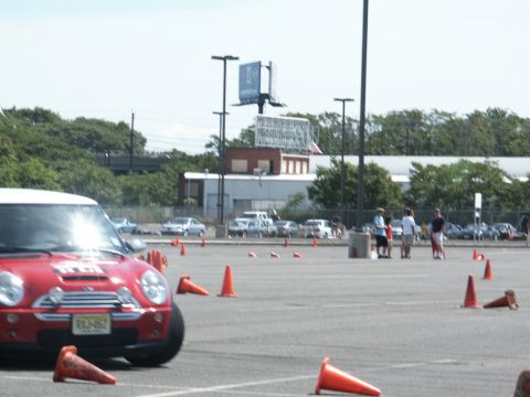 2001 Mercury Grand Marquis - Autocross event with a red Mini Cooper on course, other vehicles and spectators in the background.