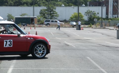 2001 Mercury Grand Marquis - A red Mini Cooper, marked with the number 73, is visible in the foreground of an autocross event scene.