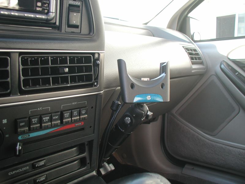 Empty HP PDA cradle on ball mount at edge of gray Ford dash with slider HVAC controls