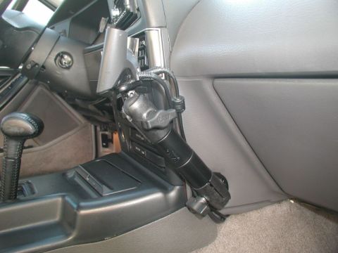 1990 Ford Thunderbird - A RAM mount is installed on the dashboard of a car, positioned near the center console and gear shifter.