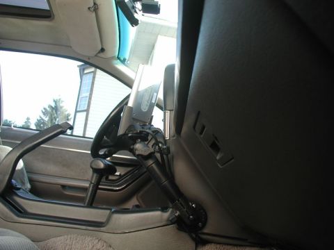 1990 Ford Thunderbird - Interior view of a car's dashboard with a PDA mount attached near the steering wheel.