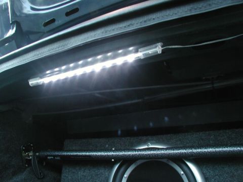 1990 Ford Thunderbird - LED light strip installed in the trunk of a vehicle, illuminating a subwoofer box.