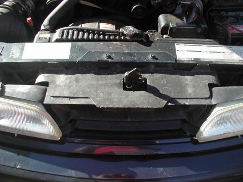 1990 Ford Thunderbird - Front view of a 1990 Ford Thunderbird's engine bay, including the radiator and headlights.