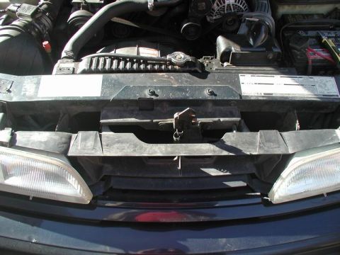 1990 Ford Thunderbird - Close-up view of a car's engine compartment, showing various mechanical components.
