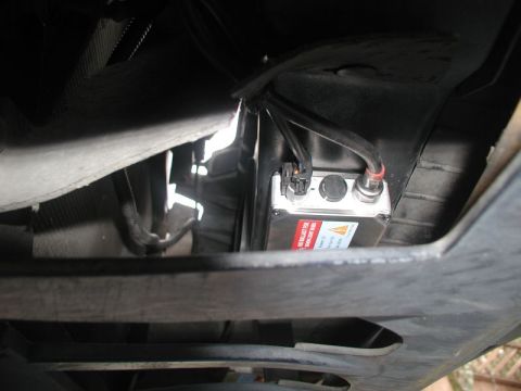 1990 Ford Thunderbird - Close-up of an HID ballast installed beneath a vehicle, a red warning label.
