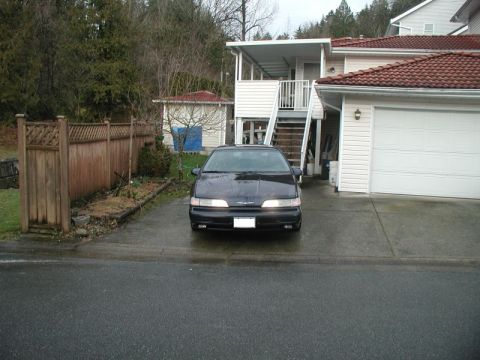 1990 Ford Thunderbird - This 1990 Ford Thunderbird is parked in front of a residential garage.