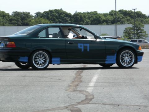 2001 Mercury Grand Marquis - A green coupe, possibly a BMW, is seen with racing number 97 and blue tape applied to its lower body panels.
