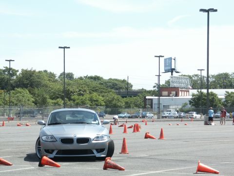 2001 Mercury Grand Marquis - Silver BMW Z4 sports car at an autocross event with cones marking the course.