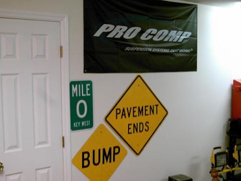 1986 Ford Bronco - Wall decorations include a Pro Comp banner and road signs.