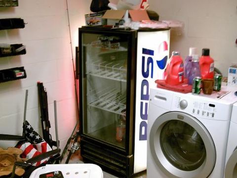 1986 Ford Bronco - A Pepsi branded refrigerator and a washing machine are visible in a room with various items.