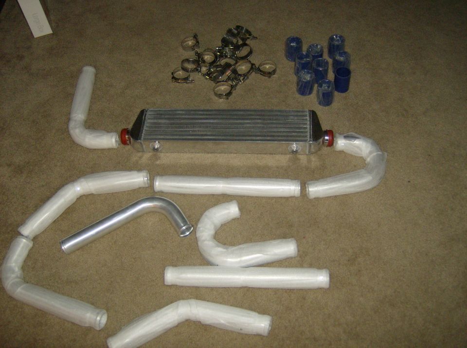 Intercooler and assorted piping sections with hose clamps and blue couplers