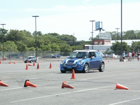 2001 Mercury Grand Marquis - A blue Mini Cooper with white racing stripes and number 18 on the door navigates through an autocross course marked by orange cones.