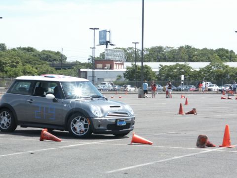 2001 Mercury Grand Marquis - A gray Mini Cooper is positioned on an asphalt course marked with orange cones.