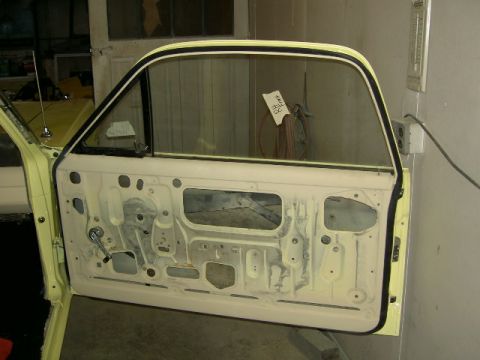 1967 Ford Ranchero - The interior of a vehicle's door is exposed, revealing its internal structure and mechanisms.