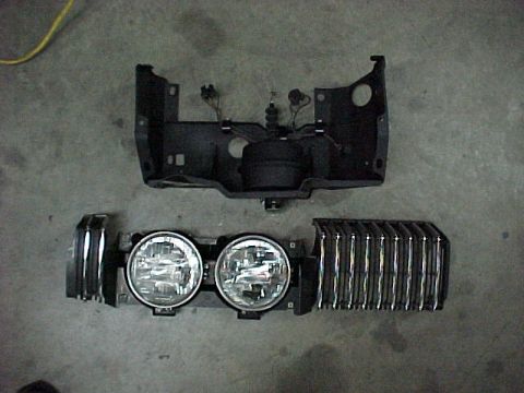 1967 Mercury Cougar - Front end parts for a 1967 Mercury Cougar, including the grille and dual headlights.