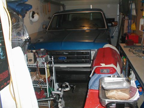1991 Ford Bronco - Front view of a Ford Bronco parked in a cluttered garage.