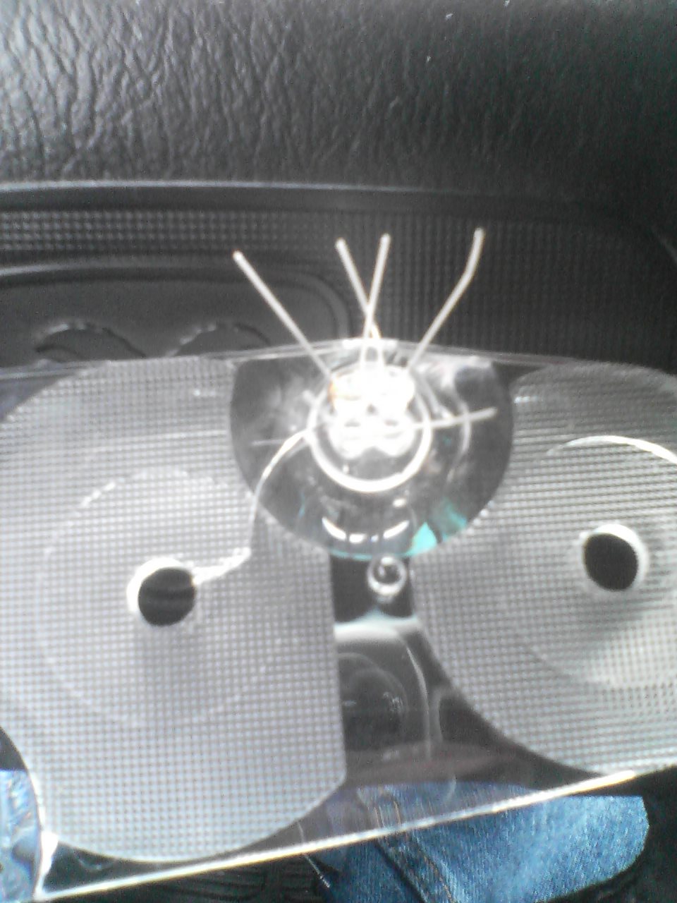 Cracked clear instrument cluster lens with wires protruding