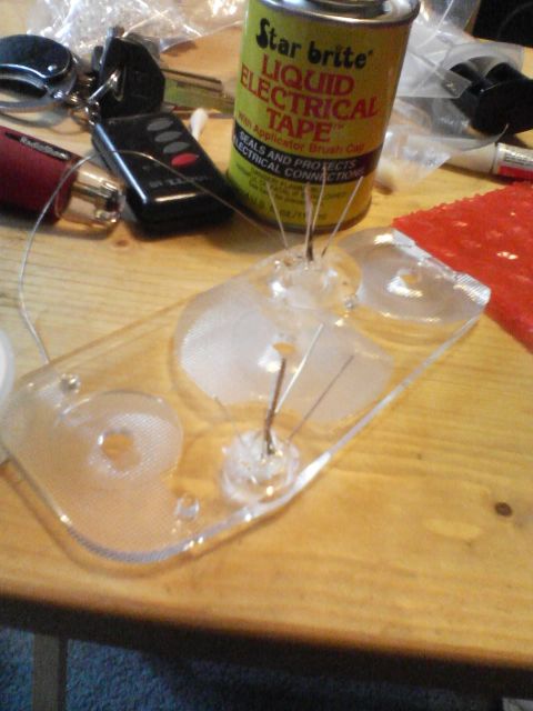 2000 Dodge Durango - A clear plastic part with wires is shown next to a can of liquid electrical tape.