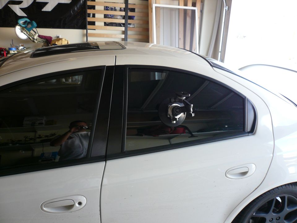 Car interior with brake rotor assembly mounted on the rear passenger window