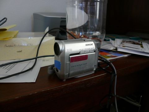 1996 Ford Probe - A silver Sony Handycam camcorder sits on a wooden desk next to papers and a printer.