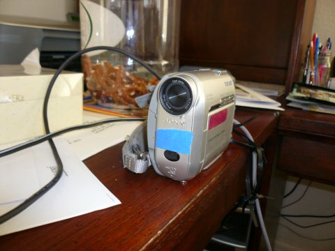 1996 Ford Probe - A Sony Handycam camcorder sits on a desk next to papers and a jar of pretzels.