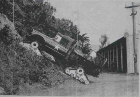 2000 Ford E350 - Truck modified with tank treads is shown on a challenging incline.