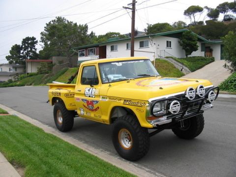 1984 Ford Bronco - Modified 1973 Ford F-Series pickup truck with racing livery and off-road tires.