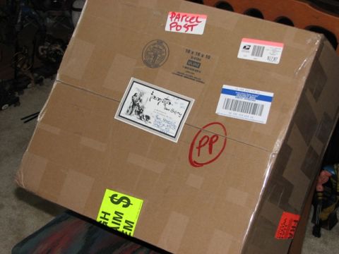 1991 Ford Bronco - A cardboard box is covered in various shipping labels and markings.