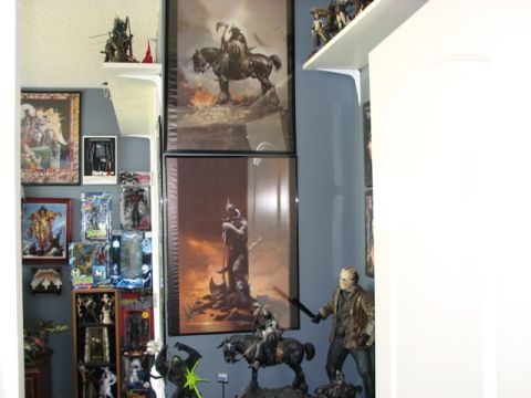 1991 Ford Bronco - Display of fantasy artwork and collectible figures, including statues and framed prints.