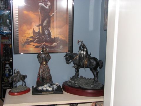 1991 Ford Bronco - A collection of fantasy-themed statues and artwork displayed on a shelf.