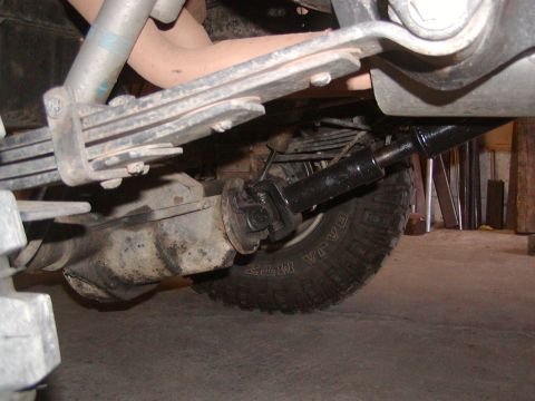 1991 Ford Bronco - Close-up of the rear suspension and axle assembly, showing the leaf springs and driveshaft connected to the differential.