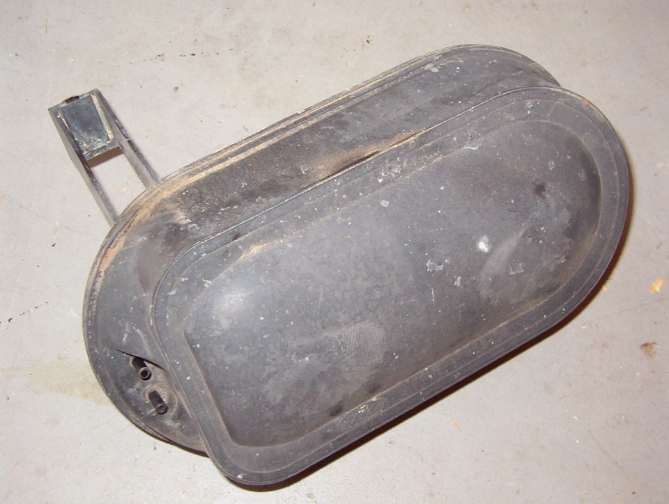 Dusty plastic or rubber automotive splash shield on concrete