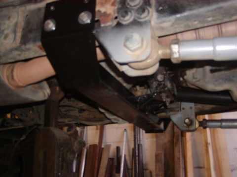 1991 Ford Bronco - Close-up of the underbody, showing aftermarket suspension components and a black bracket.