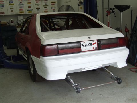 1990 Ford Mustang - Rear view of a 1990 Ford Mustang with a roll cage and custom bumper, modified for racing.