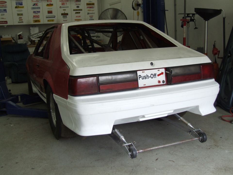 1990 Ford Mustang rear view, red and white body, roll cage, 'Push-Off' license plate