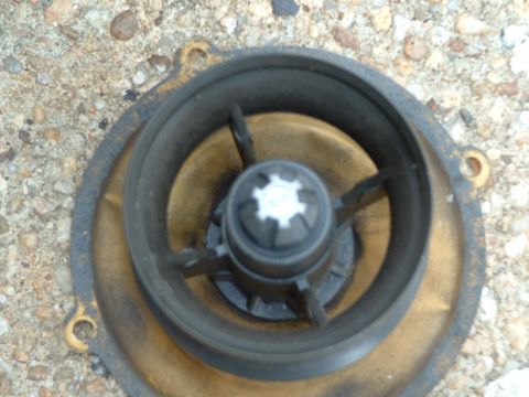 1978 Ford Bronco - A close-up view of a water pump impeller, showing its internal components and brass housing.