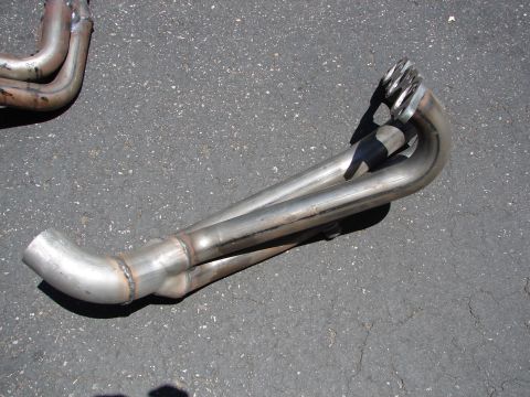 1992 Ford Taurus - Exhaust headers are shown on a paved surface, with a Supermotors.net watermark in the lower right corner.