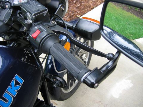 1985 Ford LTD Crown Victoria - Close-up of motorcycle handlebars, showing controls and a side mirror.