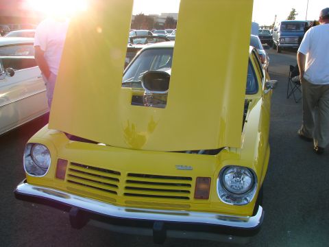 1992 Ford Taurus - A bright yellow car with its hood open, revealing a prominent engine scoop.