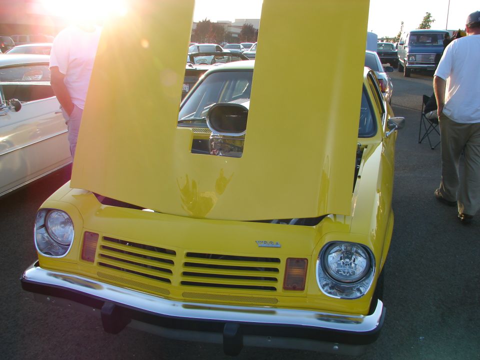 Yellow car with hood open, showing engine scoop